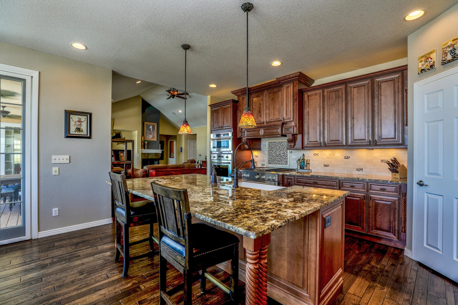 The kitchen before work began: dated timber cabinetry and granite counters