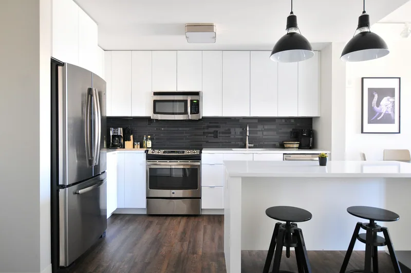 Monochrome kitchen with sculptural pendants, Coral Gables