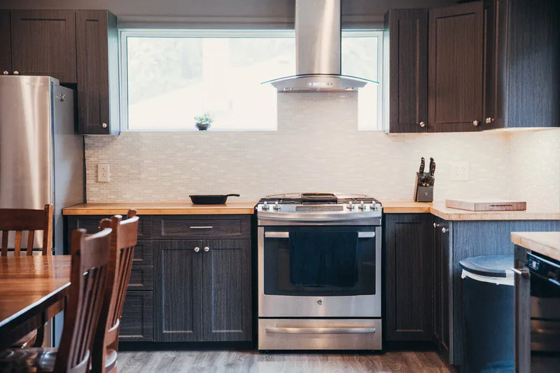 Deep navy kitchen with stainless range, Brickell tower