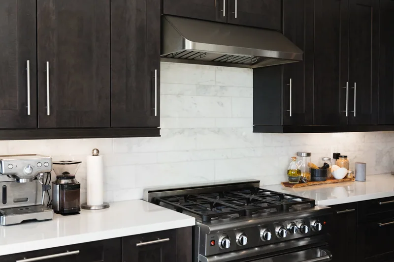 Blackened cabinetry with professional range, Pinecrest